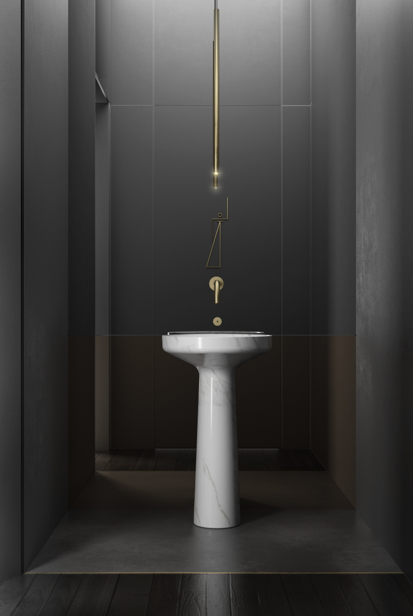 Lavabo scultoreo in marmo in un ambiente scuro con dettagli in ottone
